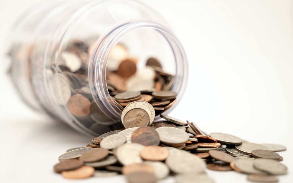Coins and a fallen jar illustrate how you can make an extra income